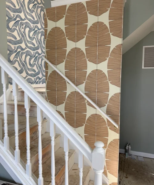 Large pattern wallpaper installed on staircase wall - professional wallpaper installer New York